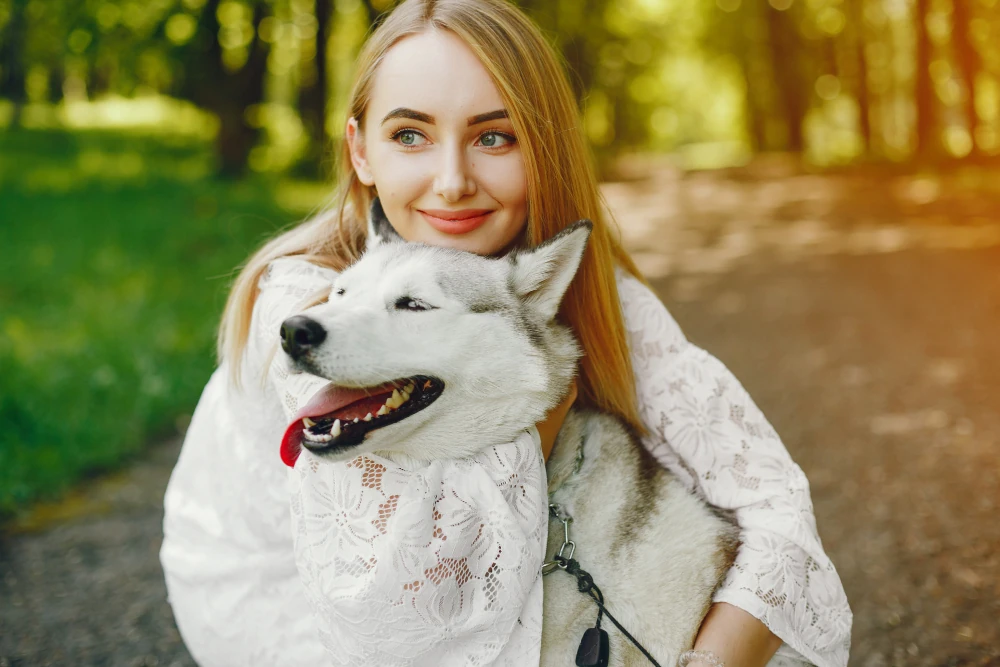 A woman enjoying time outside with her dog